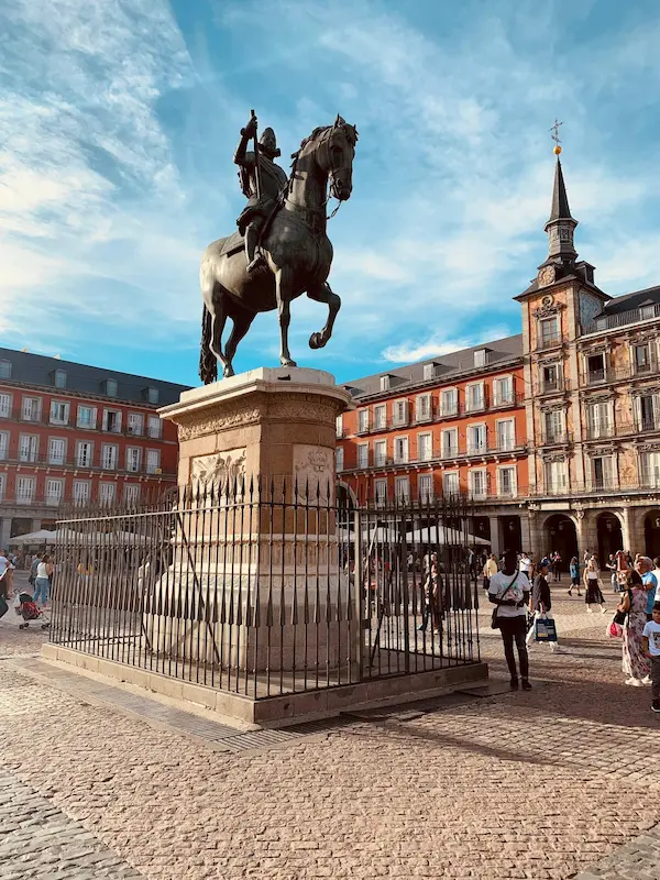 Man riding horse on a statue in front of plaza mayor madrid spain