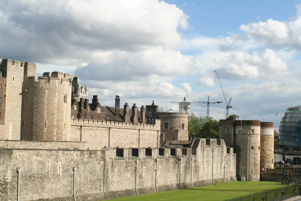 The Tower of London seen during the day, showcasing its medieval stone walls and historic architecture.