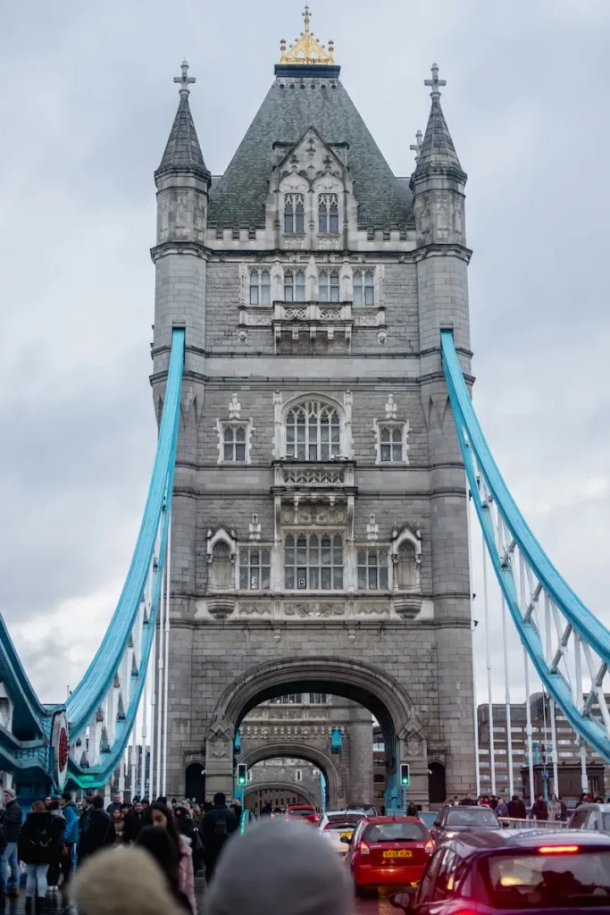 Road-level view of Tower Bridge with cars and pedestrians